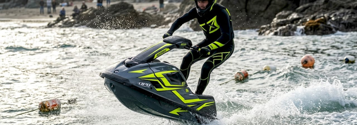 Freestyle jet ski rider jumping over waves