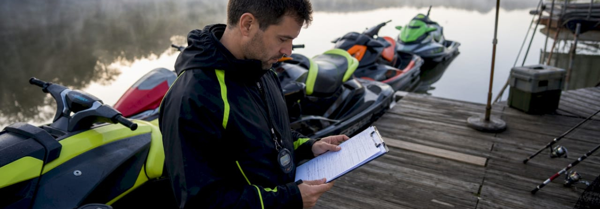 Race official reviewing jet ski classifications at marina