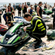Jet ski racer inspecting craft on dock before race