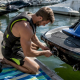 Jet ski rider inspecting sub-hook attachment