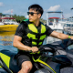 Rider on sit-down personal watercraft on calm lake