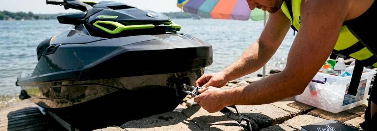 Rider adjusting jet ski tow rope on dock