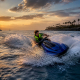Rider surfing jet ski wake on lake