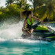 Woman performing jet ski spin on calm ocean