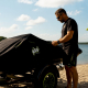 Man inspecting PWC covered by protective fabric