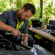 Mechanic removing spark plug from watercraft engine