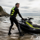 Jet ski rider preparing ocean stance on beach