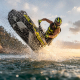 Male rider performing jet ski rotation on lake