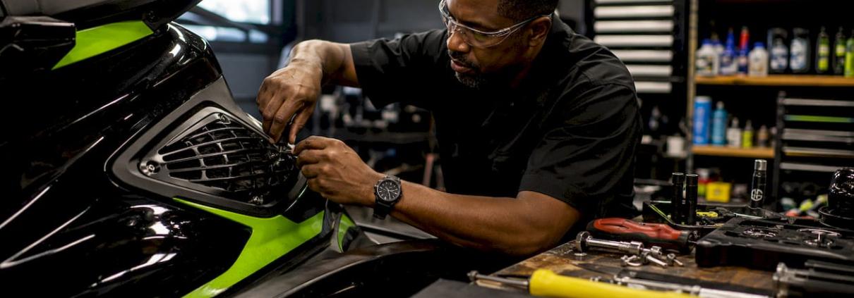 Technician installing jet ski intake grate