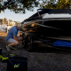 Man inspecting watercraft on trailer outdoors