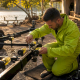 Technician adjusting PWC trailer guide rollers