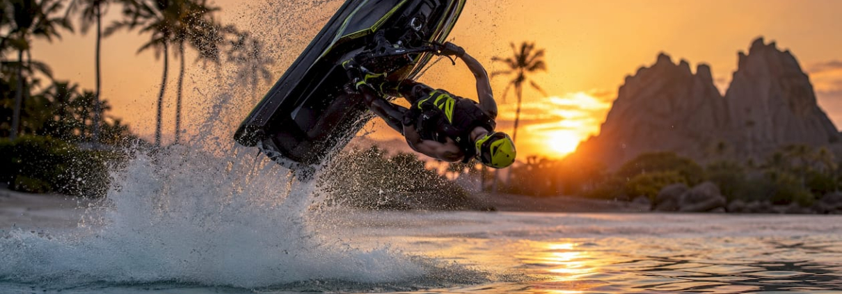 Jet ski rider performing barrel roll on lake