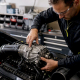 Technician installing Yamaha supercharger on PWC engine