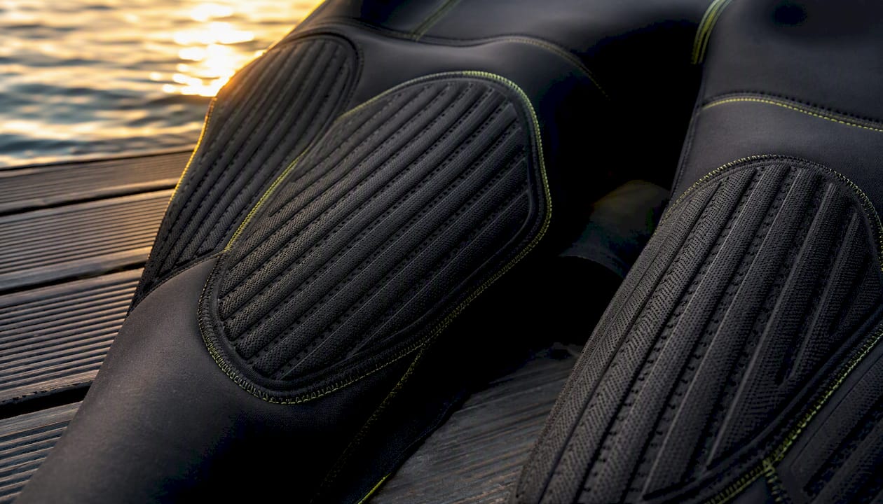 Reinforced knee and seat panels on wetsuit