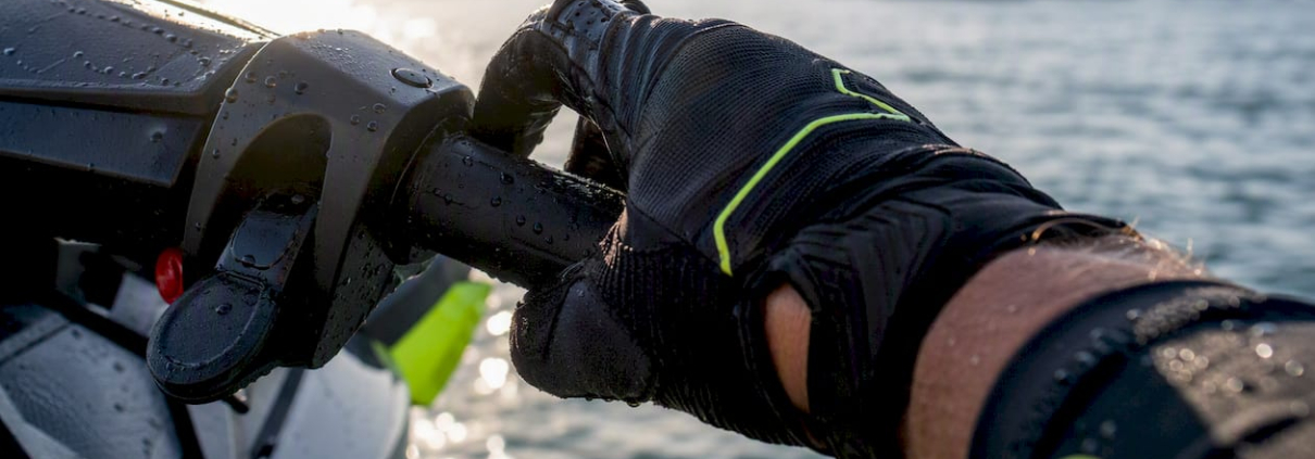 Gloved hand adjusting jet ski throttle lever