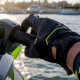 Gloved hand adjusting jet ski throttle lever