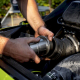 Hands installing blowback reducer in PWC exhaust