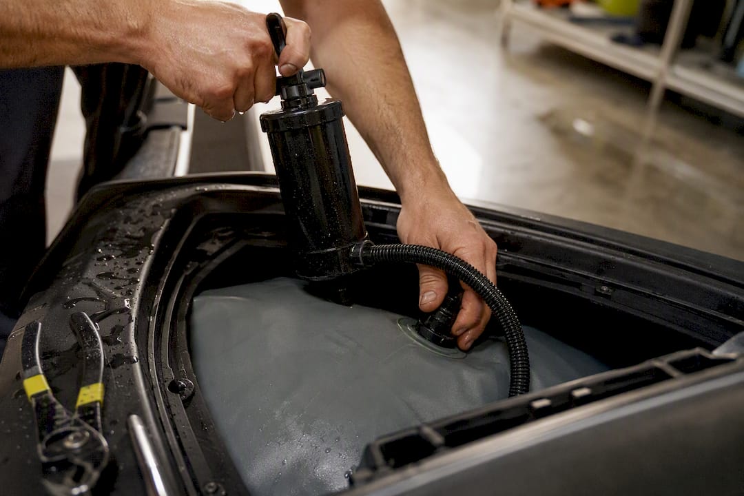 Inflating ballast bag inside jet ski hull
