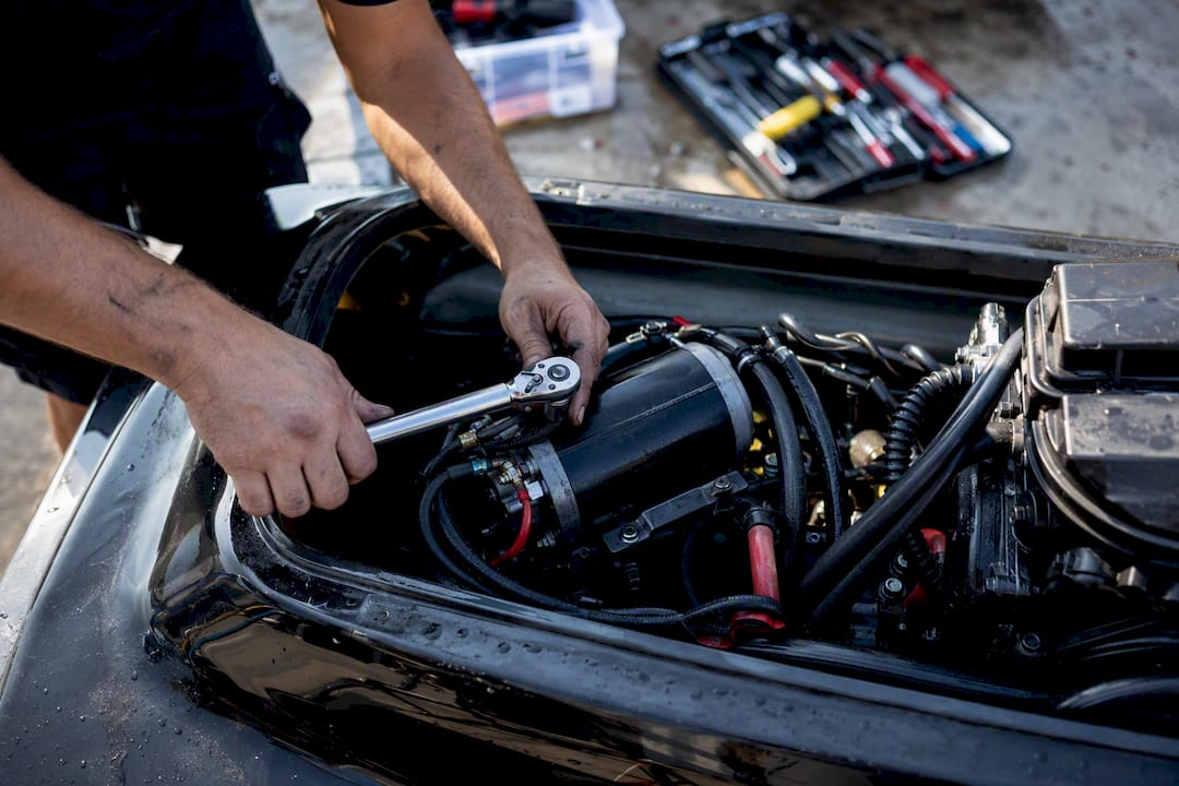 Technician installing PWC Protorque starter at race pit