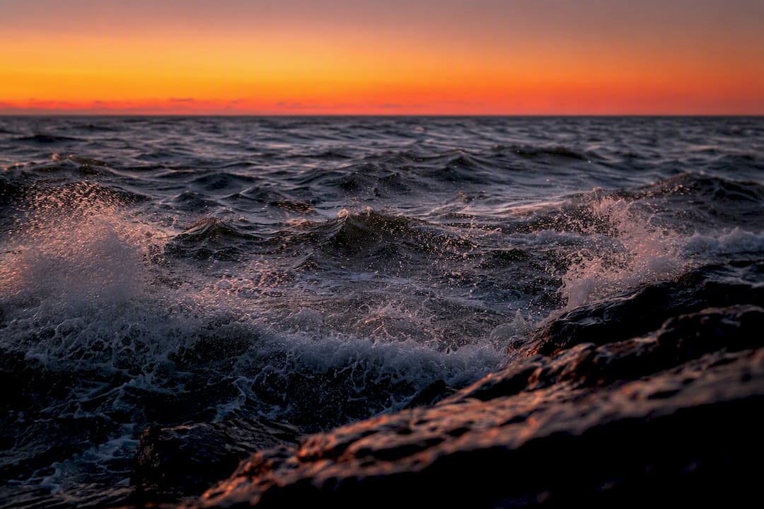 Sea with whitecaps and wind spray visible