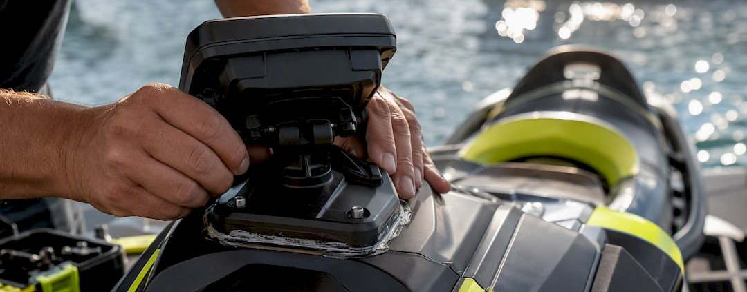 Hands installing rigid GPS mount on PWC cowling