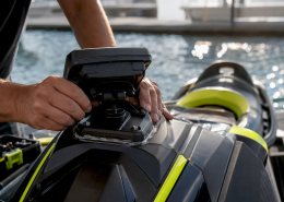 Hands installing rigid GPS mount on PWC cowling
