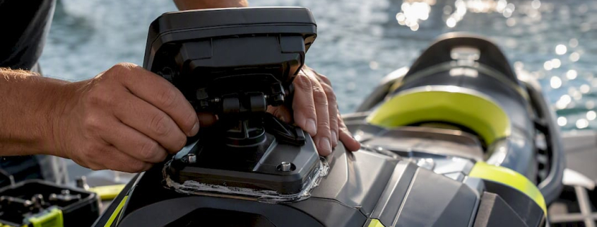 Hands installing rigid GPS mount on PWC cowling