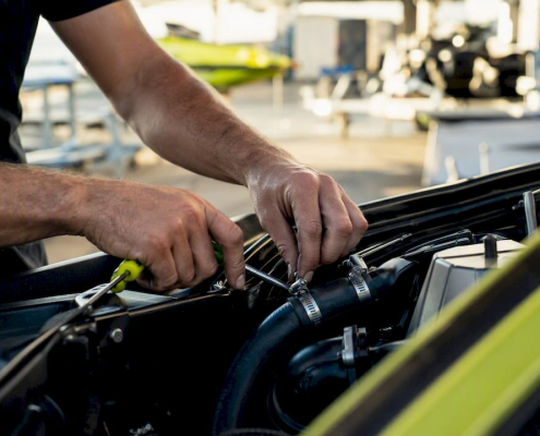 Hands maintaining jet ski cooling system parts